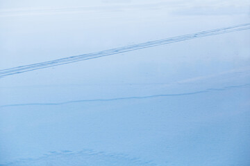 abstract footprints on pure blue ice