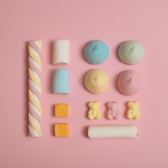 Candy composition made of fluffy marshmallows and gummy bears. Pastel minimal concept.