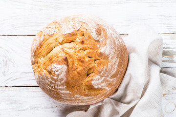 Homemade bread at white wooden table. Top view image.