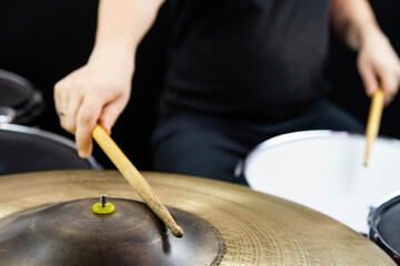 Professional drum set closeup. Man drummer with drumsticks playing drums and cymbals, on the live music rock concert or in recording studio  &nbsp;