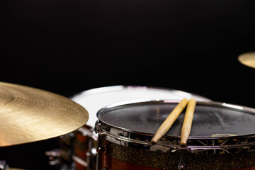 Closeup of drumsticks lying on the professional drum set. Drummer equipment. 