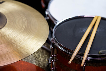 Closeup of drumsticks lying on the professional drum set. Drummer equipment. 