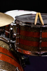 Closeup of drumsticks lying on the professional drum set. Drummer equipment. 
