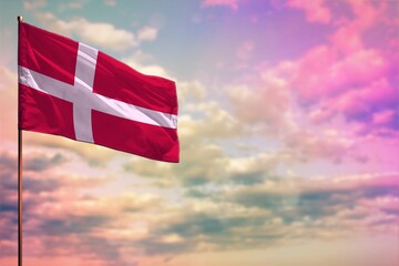 Fluttering Denmark flag mockup with the space for your content on colorful cloudy sky background.