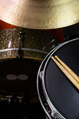 Closeup of drumsticks lying on the professional drum set. Drummer equipment. 