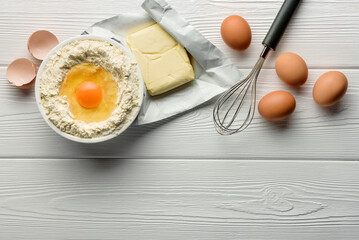 Ingredients for baking on a white wood background with copy space.