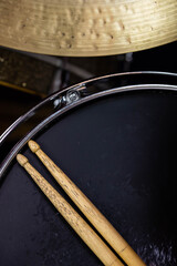 Closeup of drumsticks lying on the professional drum set. Drummer equipment. 