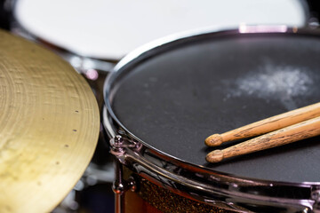 Closeup of drumsticks lying on the professional drum set. Drummer equipment. 