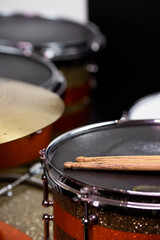 Obraz premium Closeup of drumsticks lying on the professional drum set. Drummer equipment. 