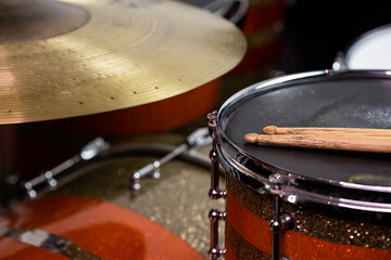 Closeup of drumsticks lying on the professional drum set. Drummer equipment. 