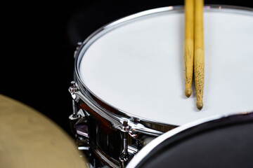 Fototapeta premium Closeup of drumsticks lying on the professional drum set. Drummer equipment. 