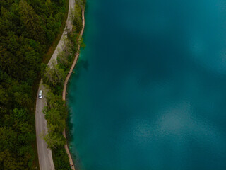 Aerial top down view of road near Lake Bled. Cloudy weather, heavy thunderstorm clouds on the horizon. Copy space. Season of tour and travel. Triglav, Slovenia, Europe