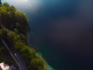 Fototapeta na wymiar Aerial view of the Bohinj lake. Travel and tours concept. Beautiful landscape ot the Triglav mountains, national park, summer forest and the church (Cerkev sv. Duha, Ribcev Laz), Slovenia, Europe
