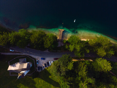 Aerial top down view of the Bohinj lake. Beautiful landscape ot the Triglav mountains, national park, summer forest and the church (Cerkev sv. Duha, Ribcev Laz), Slovenia, Europe