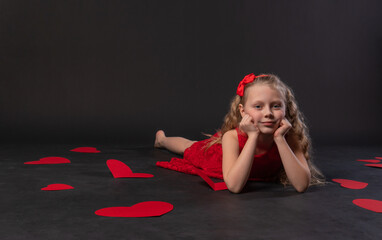 on the elbows paper hearts valentine, happiness, on the floor hearts lovely . inspiration for the honeymoon. copy space festive, hearts in red dress girl, barefoot