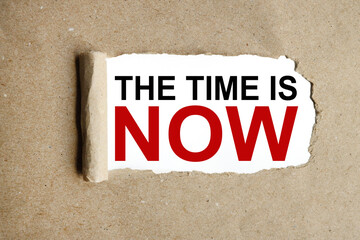 The Time is Now! text on white paper on torn paper background