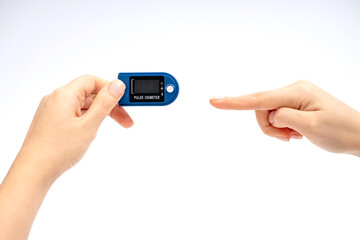 Fingertip Pulse Oximeter on finger. On white background. Device for self health diagnostic