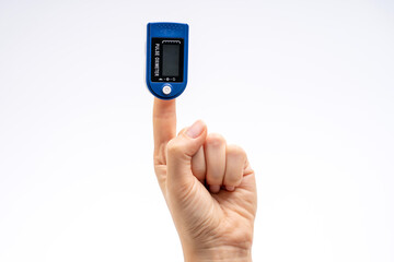 Fingertip Pulse Oximeter on finger. On white background. Device for self health diagnostic