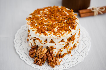 Homemade cake with honey and walnuts on a light background