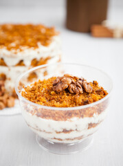 portioned homemade cake dessert with honey and walnuts on a light background