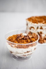 portioned homemade cake dessert with honey and walnuts on a light background
