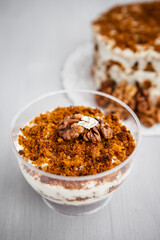 portioned homemade cake dessert with honey and walnuts on a light background