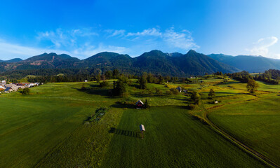 Fototapeta na wymiar Aerial view. Mountains and buildings city, road, summer day sunset. Travel and tourism. green hills. Bohinjska Bistrica Slovenia, Triglav