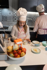 Grandmother and granddaughter preparing doughnuts at home