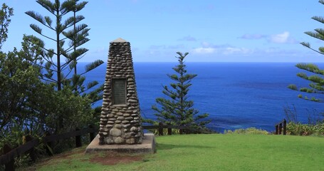 Left to right panning motion of the Captian Cook monument and scenic lookout stand at the spot on the northern coast of Norfolk Island where Captain James Cook and his officers landed in 1774