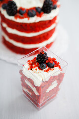homemade portioned dessert red velvet decorated with berries on a light wooden background