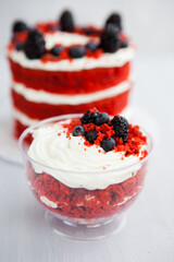 homemade portioned dessert red velvet decorated with berries on a light wooden background