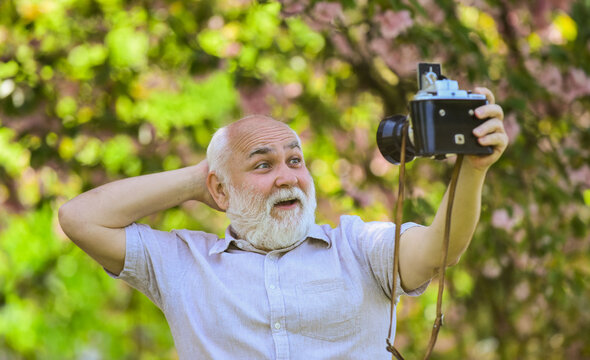 Everyone photogenic. Senior man taking selfie photo vintage camera. Self portrait. Memories in snap. Retro equipment for taking photo. Sharing his knowledge making good photo. Imitate fashion trends