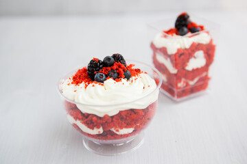 homemade portioned dessert red velvet decorated with berries on a light wooden background