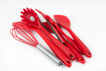 
Set of red kitchen utensils on white background