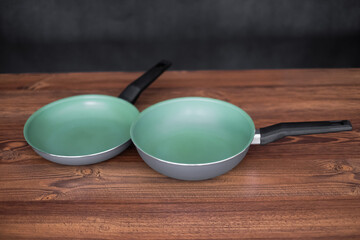 Set of grill pans on wooden table background