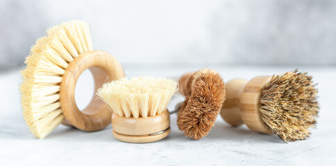 Set of wooden bamboo brushes for washing dishes and cleaning home. Zero waste eco friendly cleaning concept. Soft focus - Image