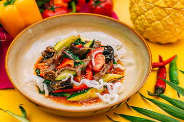 salad with eggplant, zucchini and meat on a decorated table