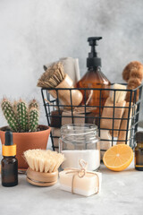 Wooden bamboo brushes, baking soda, lemon, essential oils, vinegar, natural soap Zero waste eco friendly cleaning concept Soft focus Vertical photo