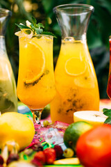 refreshing lemonade with fruits and berries on a decorated table