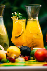 refreshing lemonade with fruits and berries on a decorated table