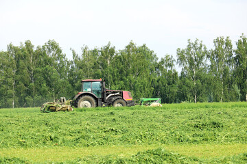 tractor mows green grass