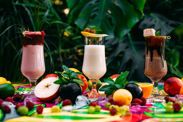 milkshake with berries and fruits on a decorated table
