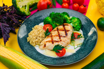 grilled chicken fillet with tomatoes on a decorated table
