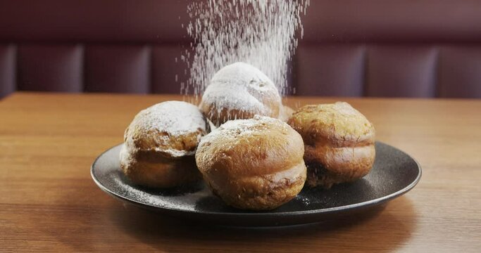  Carnival food, Shrove tuesday. Traditional home baking. Donuts sprinkled with powdered sugar.