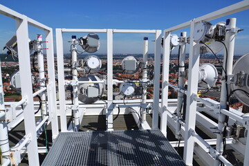 Construction for 5G broadband cellular network transmitters, telecommunication tower, wireless communication concept, clear blue sky background with copy space