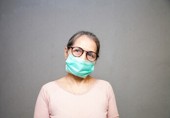 portrait of senior woman wearing protective medical mask