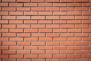 Naklejka premium Red brick wall. Background of a new brick house. Perfect brickwork. Great construction concept.