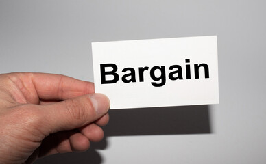 Message on the card Bargain in hands of businessman.