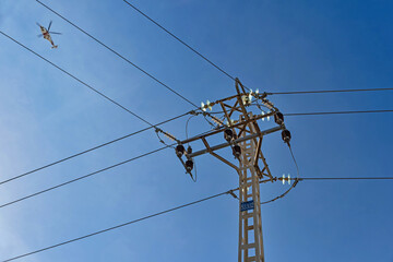 Paterna, Valencia, Spain: 01.26.2021; The helicopter and electric tower with cables