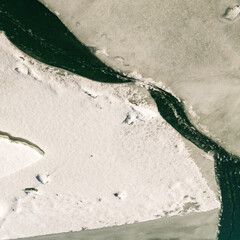 Beautiful abstract ice patterns in frozen stream